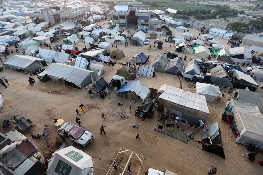  Displaced Palestinians, who fled their homes due to Israeli strikes, shelter in a tent camp, amid the ongoing conflict between Israel and the Palestinian group Hamas, on the eve of the new year of 2024, in Rafah, southern Gaza Strip.  REUTERS 